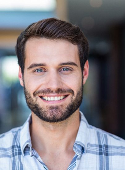 a man smiling with dental crowns in Chula Vista