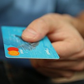 Hand extending credit card for payment