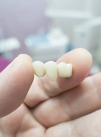 Dentist holding a dental bridge