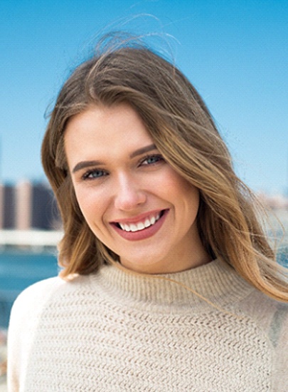 Woman with white, straight teeth smiling