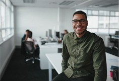 man smiling while in office 