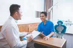 man talking to dentist about cost of cosmetic dentistry 