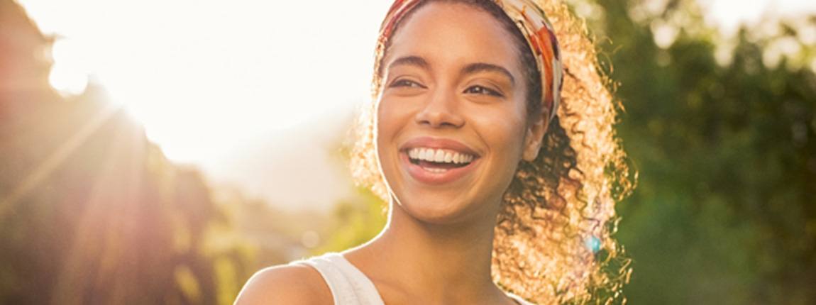 a woman smiling after getting dental crowns in Chula Vista