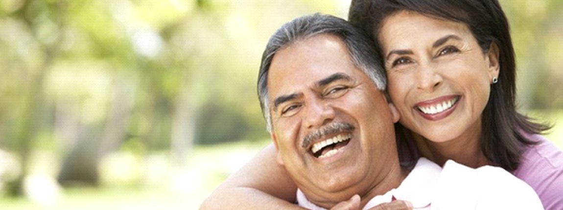 Couple with dentures in Chula Vista smiling outside