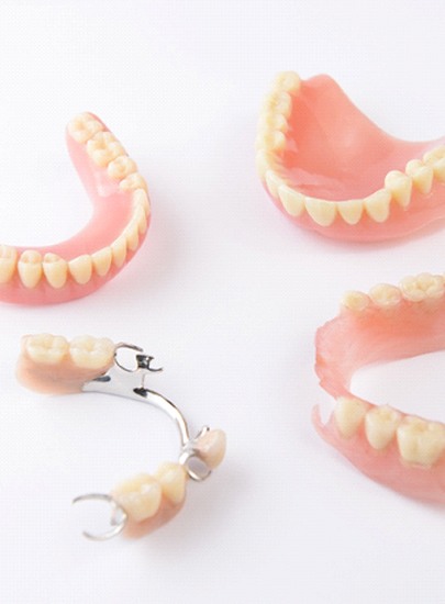 Several types of dentures in Chula Vista on white background