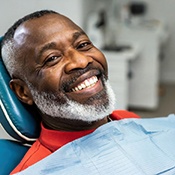  smiling older man after replacing his teeth