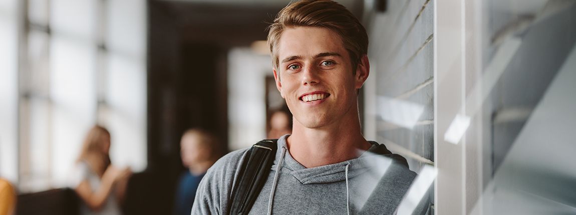 Young man with healthy smile after tooth extractions