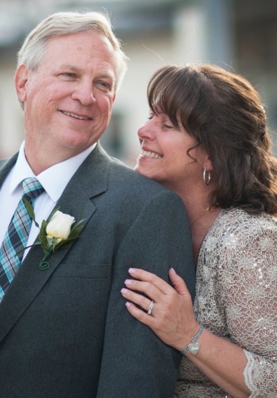 Man and woman smiling at wedding