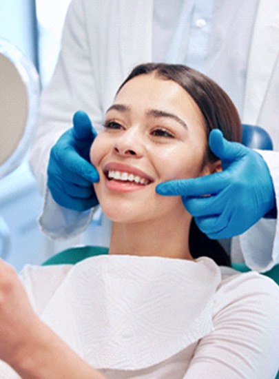 A woman admiring the results of her smile makeover