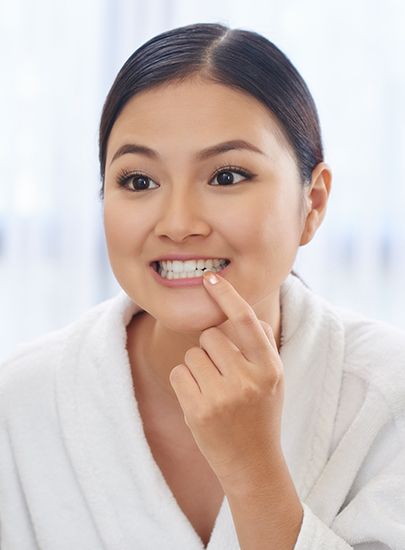 Woman looking at healthy smile after antibiotic therapy