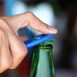 Man opening bottle with bottle opener