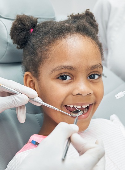 Young girl smiling during children's dentistry visit