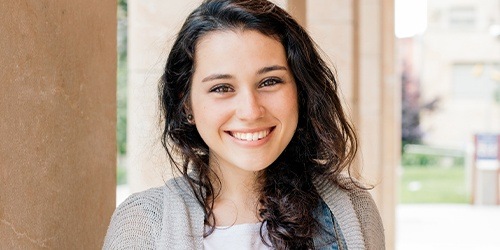 Young woman with beautiful smile after Invisalign clear braces treatment