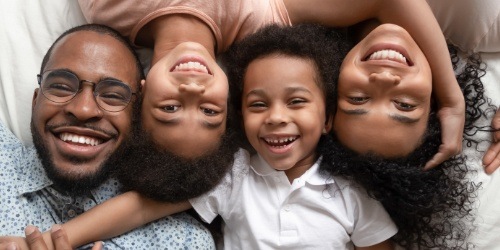 Family of four with healthy smiles thanks to preventive dentistry