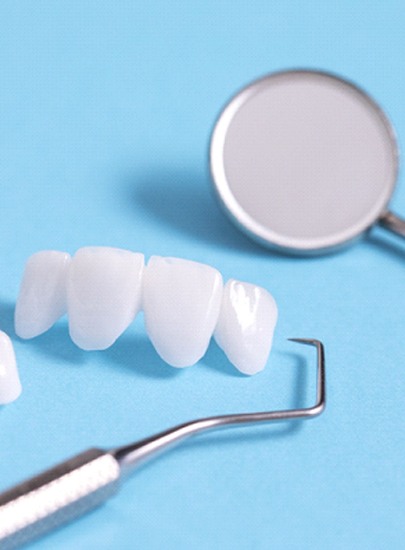 Dental tools lying next to veneers