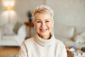 Older woman with shorter hair smiling at the camera