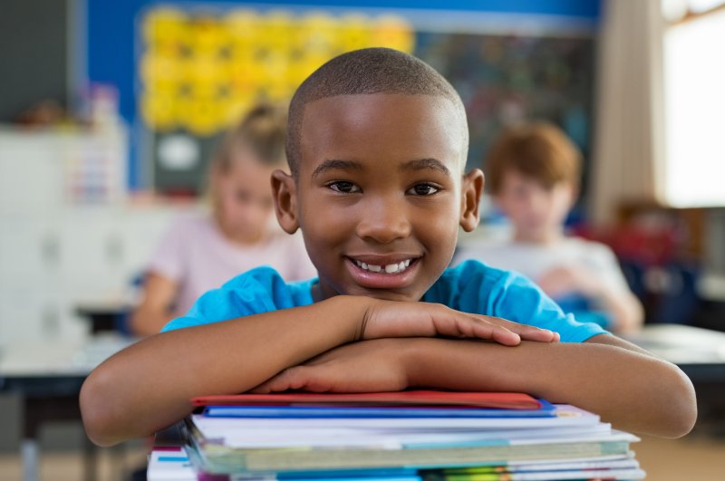 young boy smiling in school