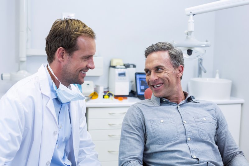 person speaking with cosmetic dentist about cavity treatment