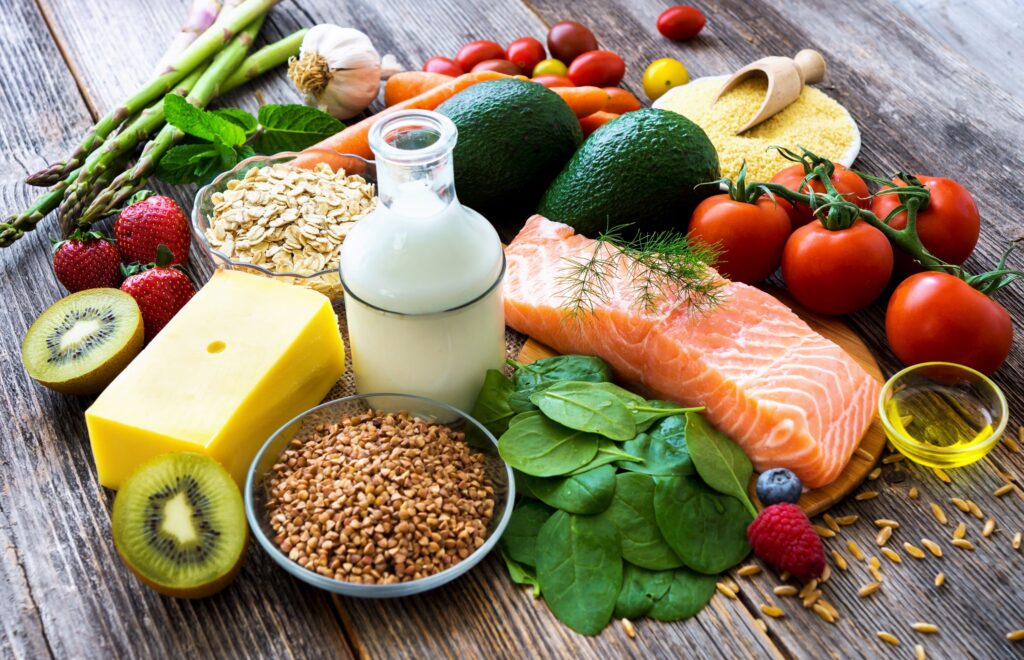 Variety of wholesome foods together on a wooden surface